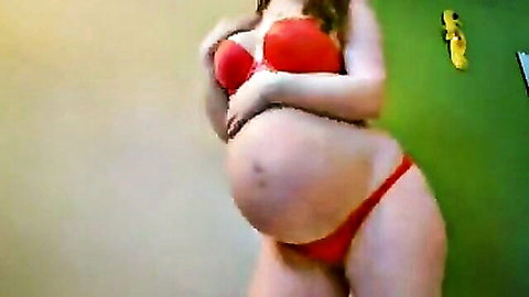 Pregnant babe in red bra and thong squeezing her huge tits with big belly