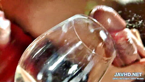 Japanese woman holding wine glass near erect penis in uncensored JAV group sex