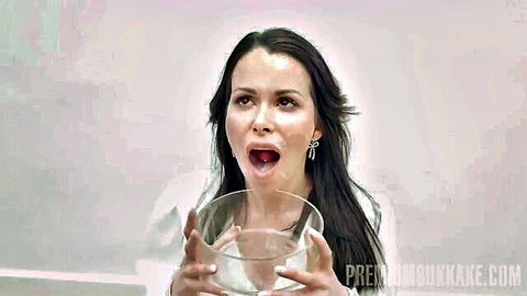 Jessy Jey with open mouth holding cum bowl in bukkake scene