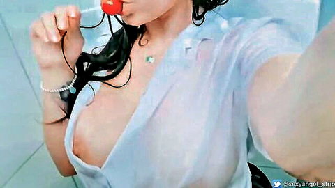 Brunette influencer sucks red lollipop with wet see-through shirt exposing perky tits in bathroom