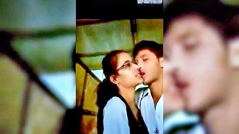 Indian couple in glasses passionately kissing in classroom