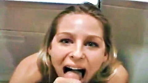 Blonde woman with intense gaze performing deep blowjob close-up