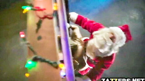 Lena in sexy Santa suit hanging upside down with holiday lights tease