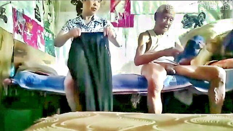 90-year-old Asian man exposed with young Asian prostitute holding clothes