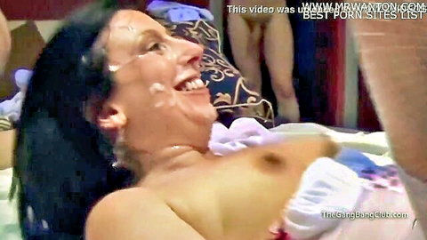 Brunette smiling with facial cumshot and cum in mouth, topless