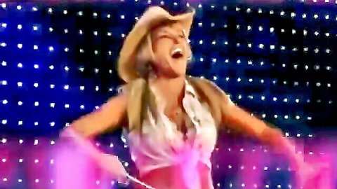 Michelle McCool in sexy white top and cowboy hat, posing on stage