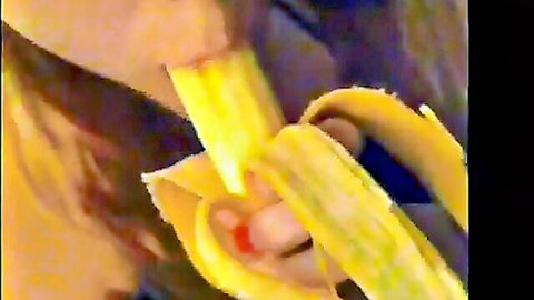 Hand peeling yellow banana exposing soft white flesh in closeup tease