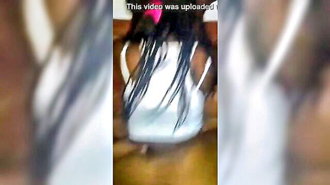 Ebony woman with long braids in white tank top, bent over from behind