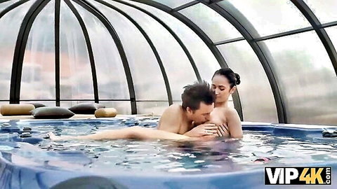 Older man embraces nude slim Asian girl in steamy jacuzzi intimacy