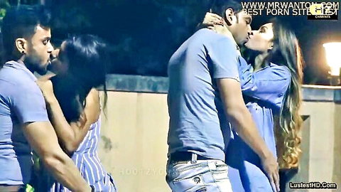Hot South Asian couple in intense neck-grabbing kiss outdoors at night