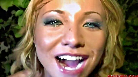 Excited blonde smiling wide at frat party, ready for fun