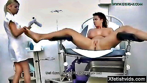 Blonde nurse in uniform examines naked man in stirrups, medical fetish scene