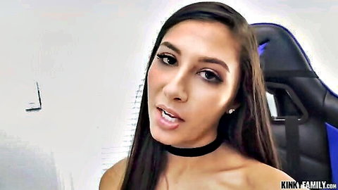 Young brunette teen with choker necklace opens mouth seductively in gaming chair