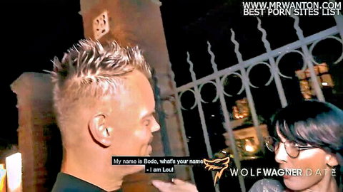 Blonde guy Wolf picks up dark-haired glasses girl Lou outdoors at night on public date