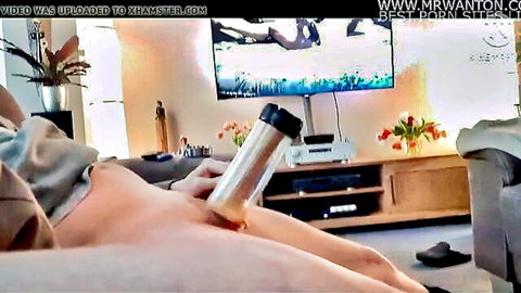 Wife masturbates by fucking her wet pussy with clear glass dildo on living room couch
