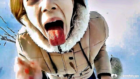 Blonde stepsister teases with open mouth and tongue outdoors in winter jacket