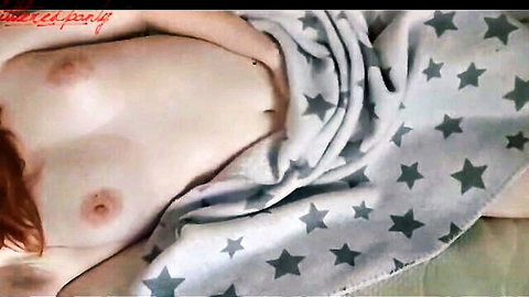Gorgeous ginger redhead topless in bed, blanket tease revealing perky breasts