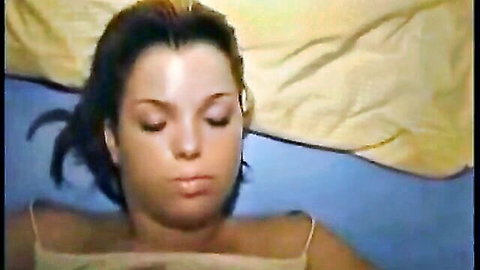 Cute brunette babe lying back with eyes closed, ready for facial cumshot
