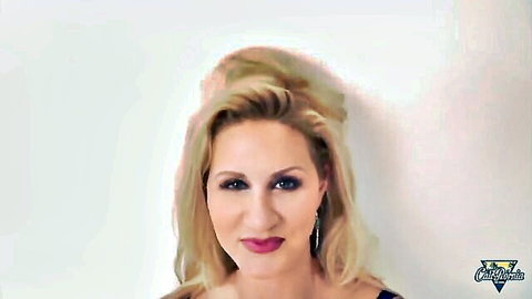 Ryan Conner busty blonde cougar smiling in low-cut blue dress