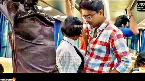 Indian man passionately kissing short woman on crowded public bus interior
