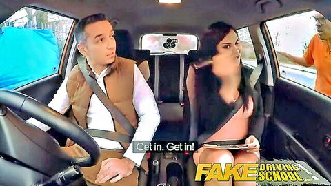 Brunette in short skirt and fur vest sits passenger side in fake driving school car with male driver as black instructor urges them on