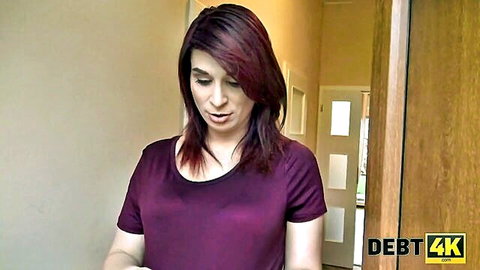 Redhead MILF in tight purple top stands seductively in hallway doorway