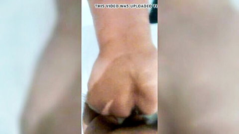 Blurry closeup of clenched light-skinned fist pressed into flesh during rough fisting action