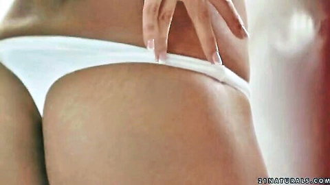 Skinny fair-skinned girl spreads small ass cheeks revealing shaved pussy in white thong