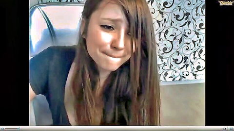 Cute Asian camgirl with long brown hair, teasing pout on Ohmibod webcam