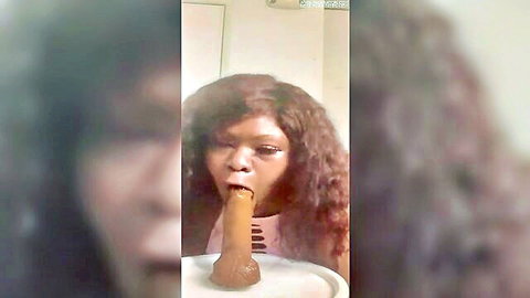 Ebony babe with curly hair sucking thick veiny brown dildo deeply