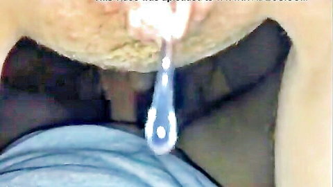 Close-up of thick cum drop dangling from roof of open mouth after blowjob with pubic hair visible