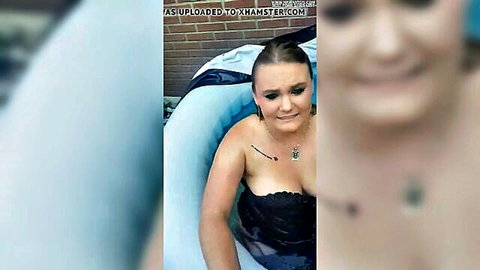 Busty blonde showing massive cleavage in black lace top sitting in inflatable pool