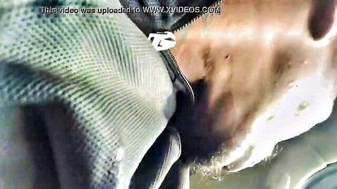 Blurry close-up of shiny green fabric with heavy XVIDEOS watermarks obscuring content