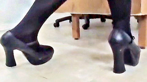 Seductive woman in black stockings and platform heels