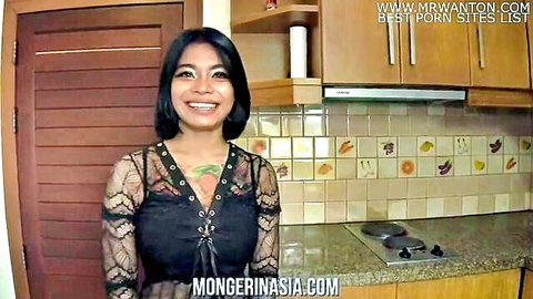 Smiling Thai bimbo with big boobs in sexy black lace top