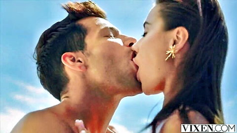 Passionate kiss between brunette beauty and handsome stranger on sunny vacation beach