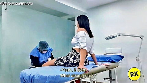 Asian woman in crop top and skirt teases doctor during exam