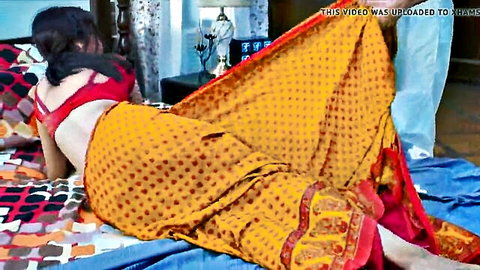 Curvy Indian woman in yellow saree lies seductively with lover