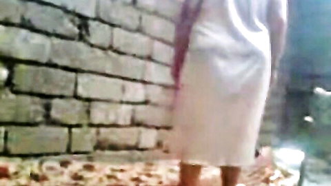 Arabic friend's mom in white dress, back view against wall, mature amateur solo