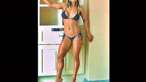 Blonde WWE diva Kaitlyn in polka-dot bikini, toned body pose