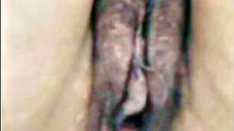 Closeup of mature hairy pussy with wet spread labia and inner folds visible