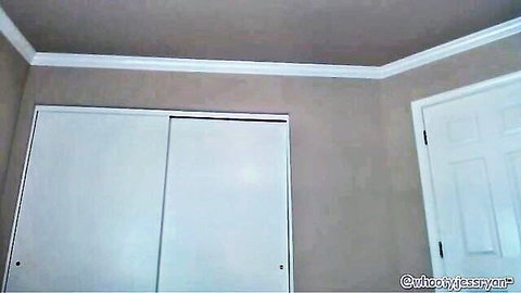 Empty light gray bedroom corner with white sliding wardrobe door and watermark