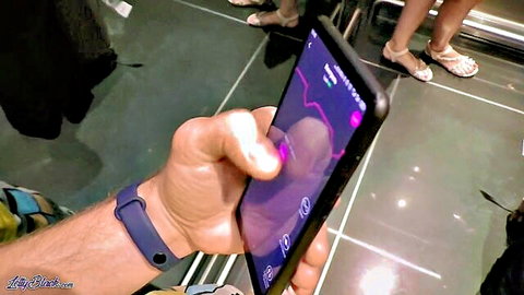 Man checks spiking heart rate on phone from remote vibrator in public store