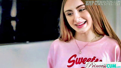 Smiling step-sis in pink sweater teases viewer playfully