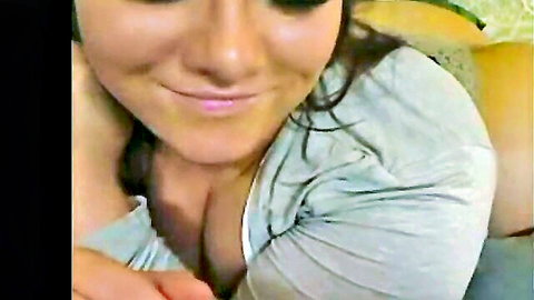 Taylor Thomas smiling with deep cleavage in gray top