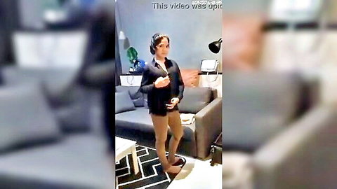 Southeast Asian girlfriend in blazer skirt stockings poses with game controller on couch