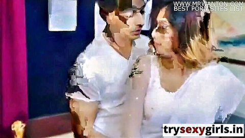 Indian couple in white shirts gazing passionately in intimate homemade moment