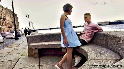 Alex Swon in short blue dress chatting with guy outdoors in Teeny Lovers