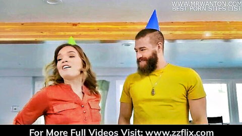 Blonde woman and bearded man in party hats smiling in kitchen - Brazzers hot roommates
