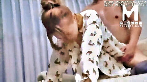 Blonde woman in patterned pajamas touched intimately by shirtless man from behind